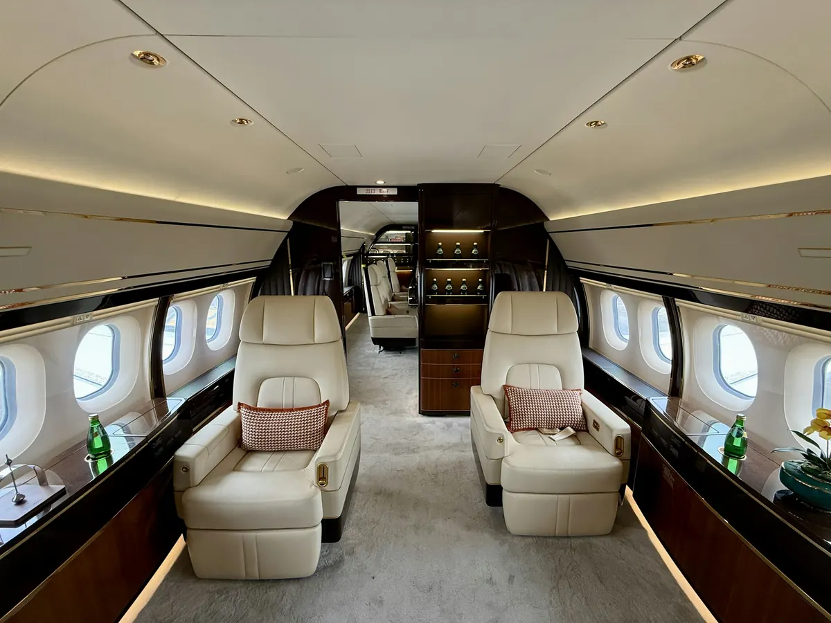 Large-cabin jet interior with cream leather club seats