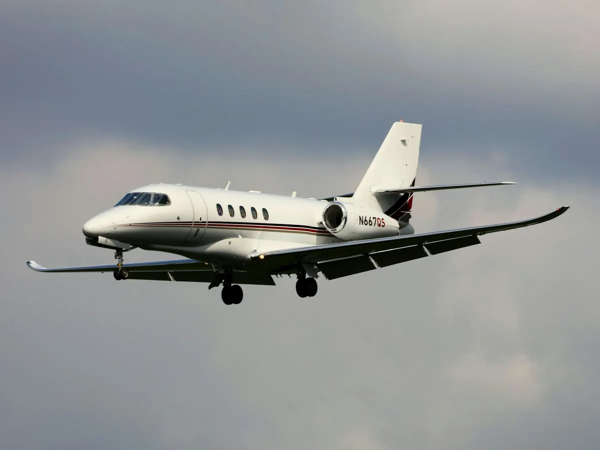 Business jet climbing above the clouds